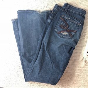 Long dark buckle jean with flare leg